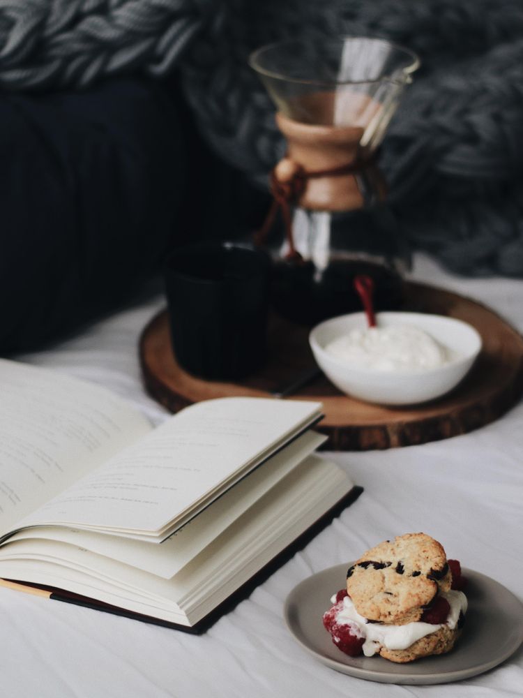 Open book beside filtered coffee and cake
