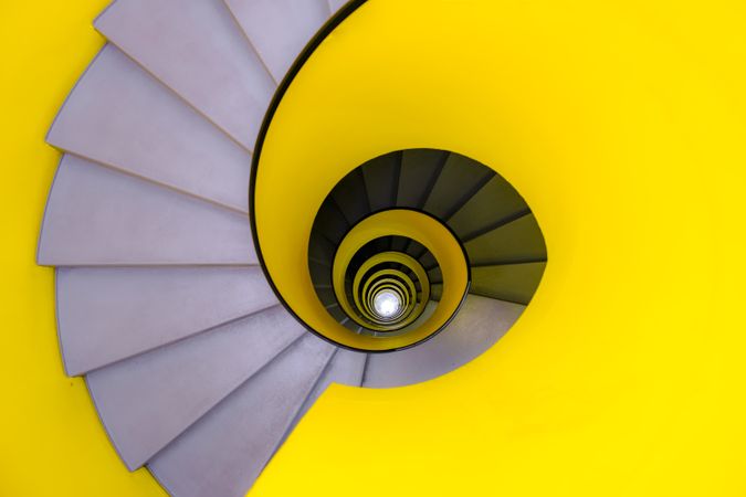 Top view of yellow and gray spiral stairs