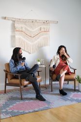 Woman laughing at man while both are giving a talk
