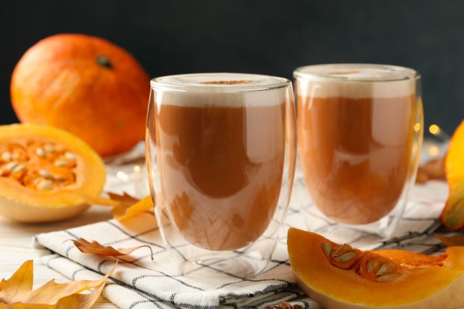 Composition with pumpkin latte on wooden table