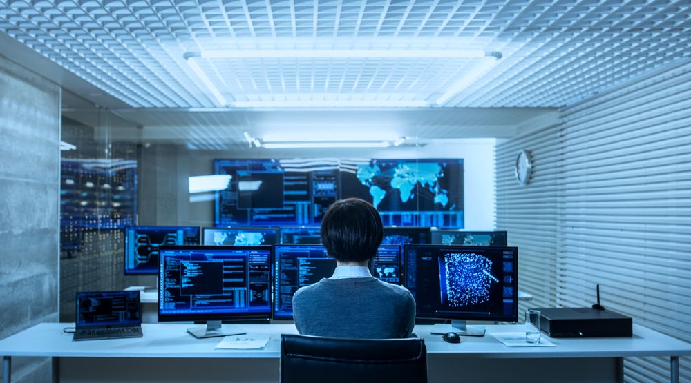 Back View of the IT Engineer Working with Multiple Monitors Showing Graphics, Functional Neural Network.
