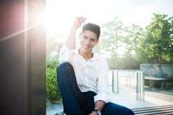 Smiling modern man on bench