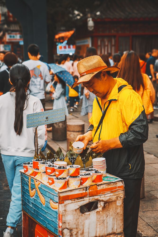 Middle aged man at the stand selling drinks