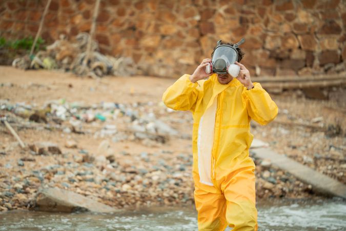 Environment scientist wearing chemical protective cloth and mask before working