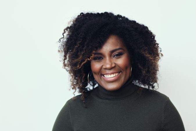 Portrait of a Black woman smiling in studio shoot