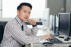 Serious Asian businessman trader looking at camera 5rnq35