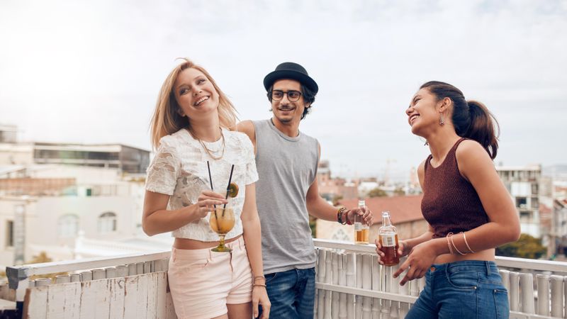 Diverse friends having rooftop party