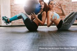 Two sporty women training with medicine ball in gym 5aOdKb