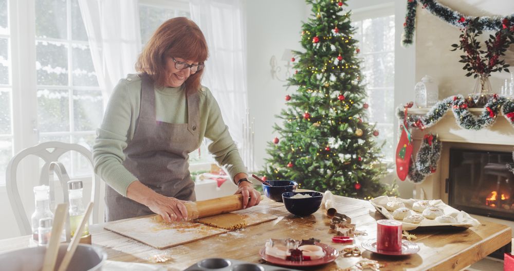 Portrait of Mature Female Preparing Dough for Making Gingerbread for Christmas at Home.