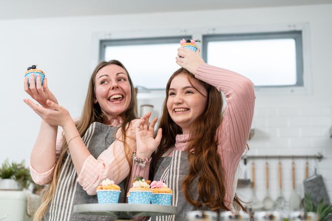 Daughter and daughter goofing around with cupcakes