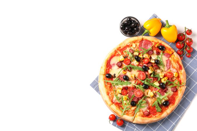 Tasty pizza, ingredients and towel isolated on blank background