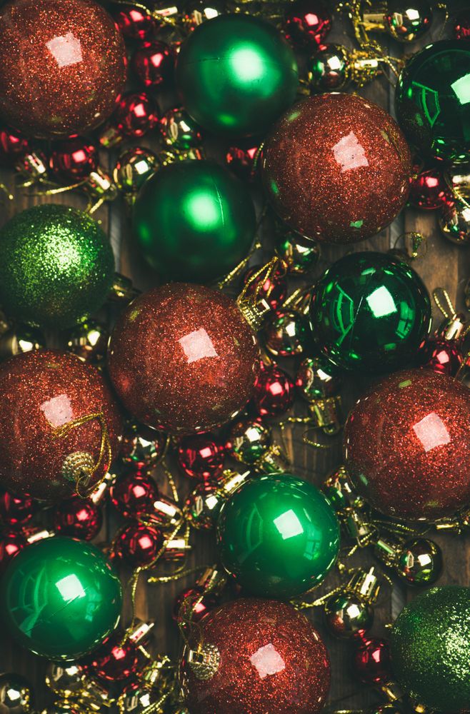 Close up of tree ornaments, large and small red, green and gold baubles, vertical composotion
