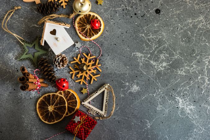 Christmas ornaments and dried fruit slices on marble table
