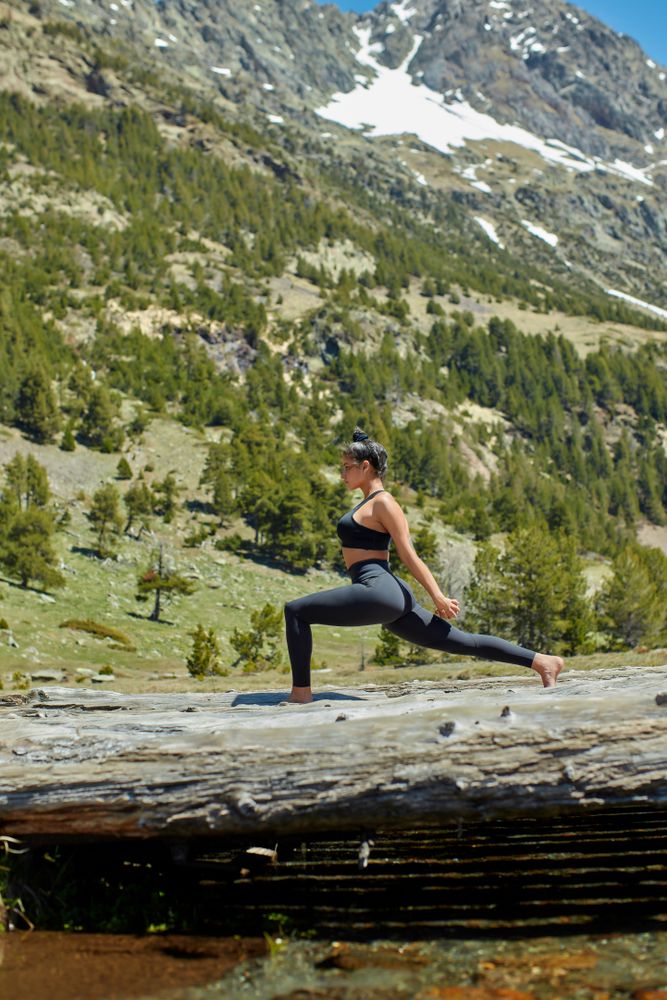 Young woman practicing yoga in the mountains