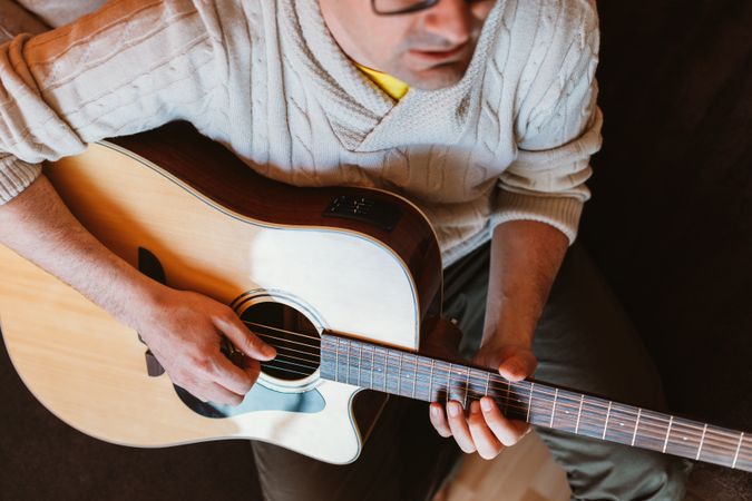Man playing the guitar at home