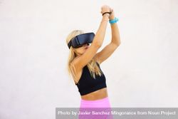 Fit woman using VR headset to play sports game 0PjN1l