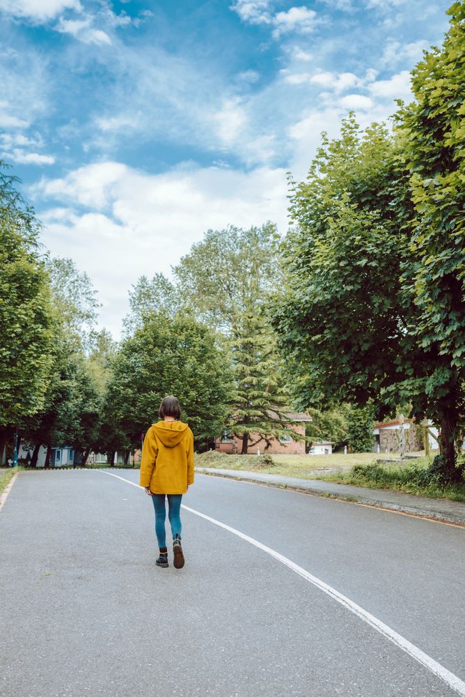 Anonymous woman walking along road