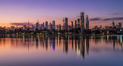 City skyline of Melbourne, Australia across the sea at sunset 0PJG24