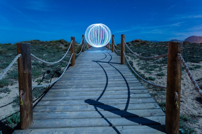 Abstract ball on footbridge between lands