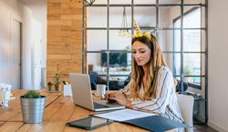 Business woman with unicorn headband working