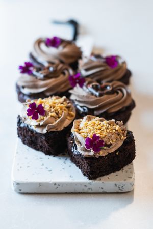 Sweet sponge cakes with whipped cream on table