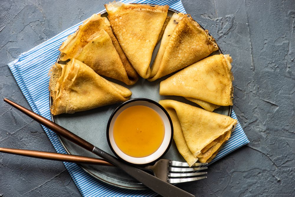 Plate with pancakes served with honey