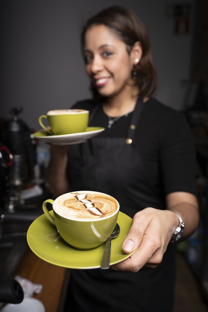 Latina woman with cappuccino cups