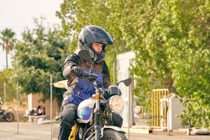 Serious woman riding motorbike during lesson