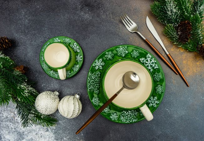 Top view of green Christmas themed bowls, cup and plates