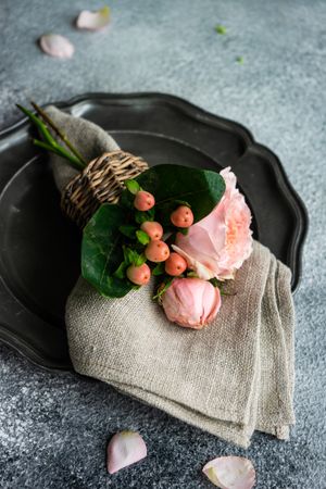 Delicate pink flowers on grey napkin and plate