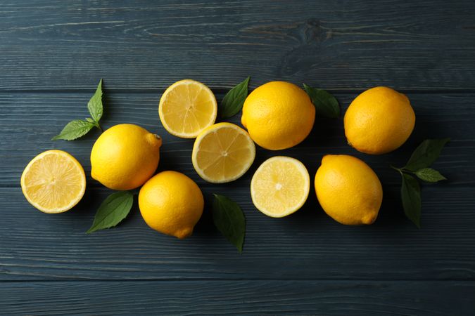 Fresh lemons on wooden background, top view. Ripe fruit