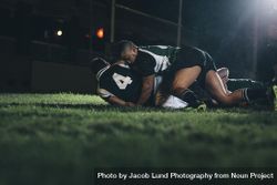 Rugby players fight for the ball on professional rugby stadium 48O3j5