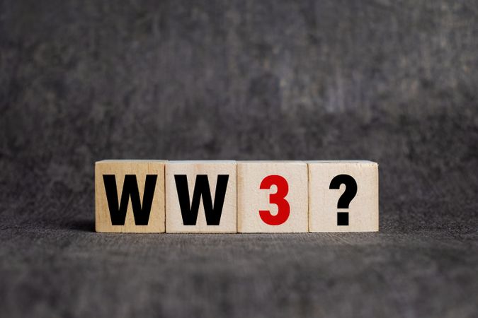 world war 3 with question mark on wooden blocks isolated on dark background