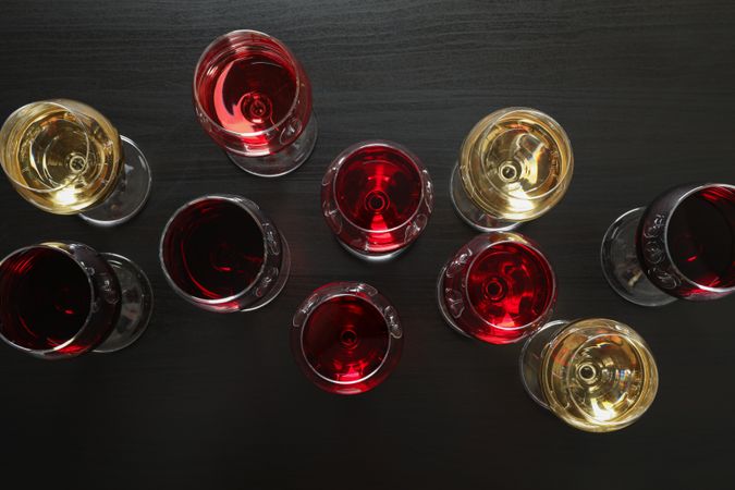 Flat lay. Glasses with different wines on dark background, copy space