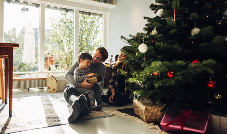 Family celebrating Christmas morning with gifts at home