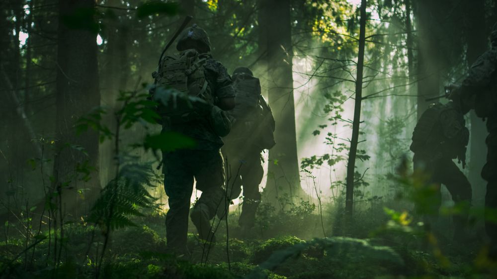 Fully Equipped Soldiers Wearing Camouflage Uniform Attacking Enemy, Rifles Ready to Shoot.