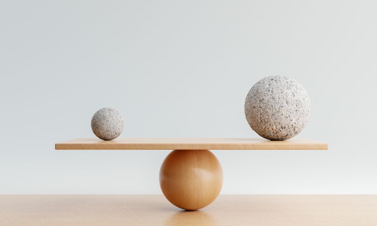 Spheres being balanced on wooden scale