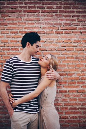 Happy couple having fun and embracing in the street