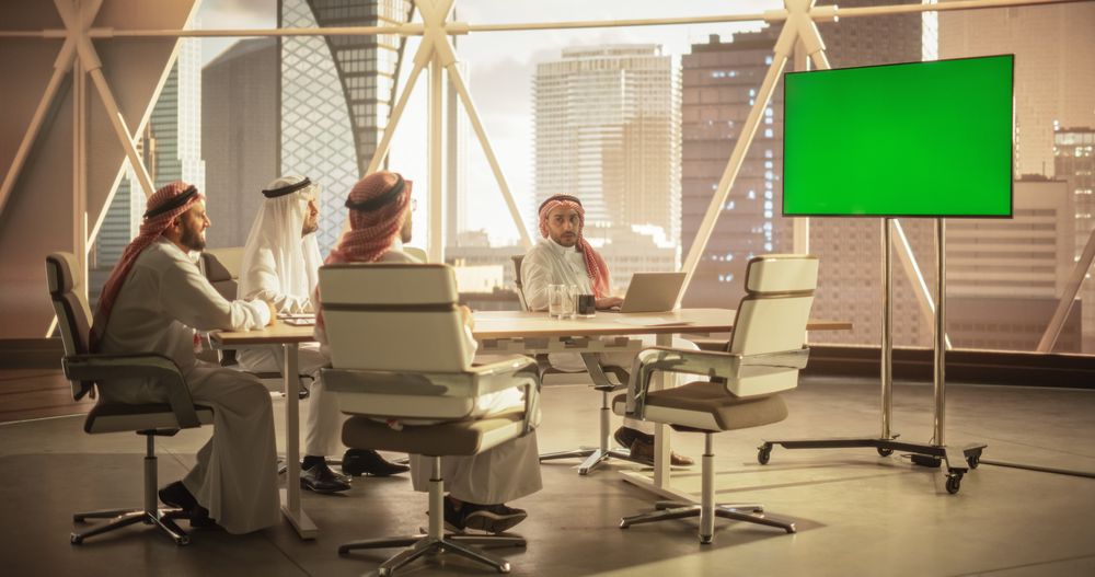 Group of Middle Eastern Executives and Management Having Conference Video Call with a Remote International Office.