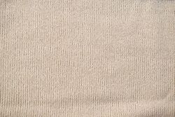 Detailed cream or vanilla knitted fabric background texture.