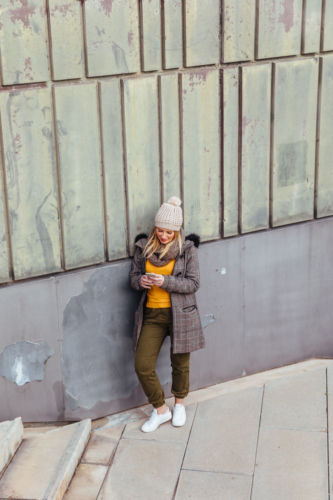 Portrait of blonde woman writing on her phone
