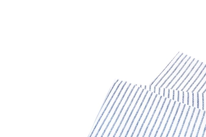 Folded fabric napkin isolated on plain background