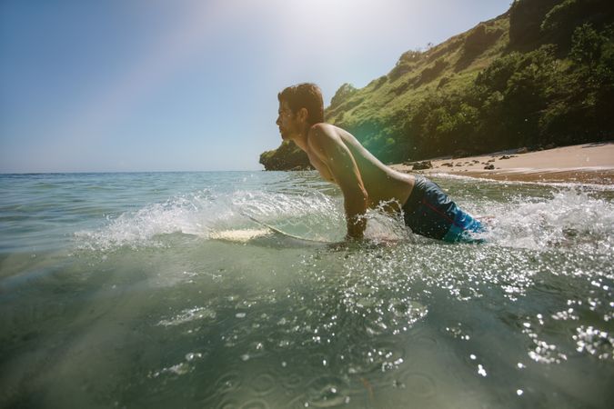 Young man doing water surfing in sea