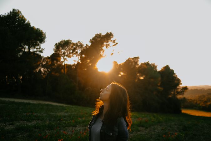 Woman walking on meadow and enjoying freedom