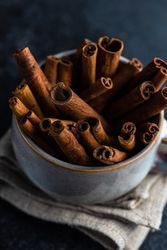 Side view of cinnamon sticks in large mug