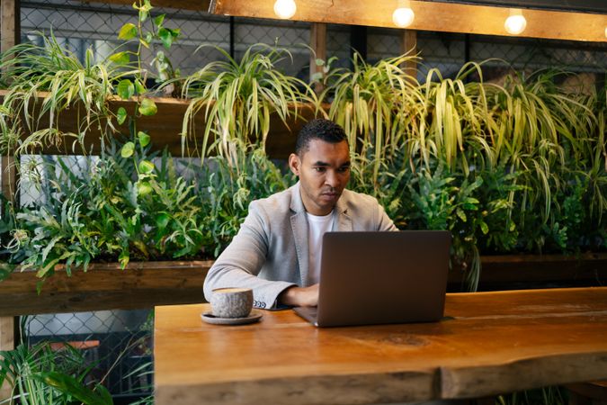 Man working on laptop at cafeteria