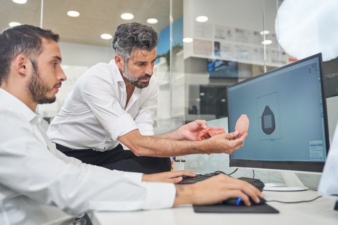 Engineers designing face mask on computer