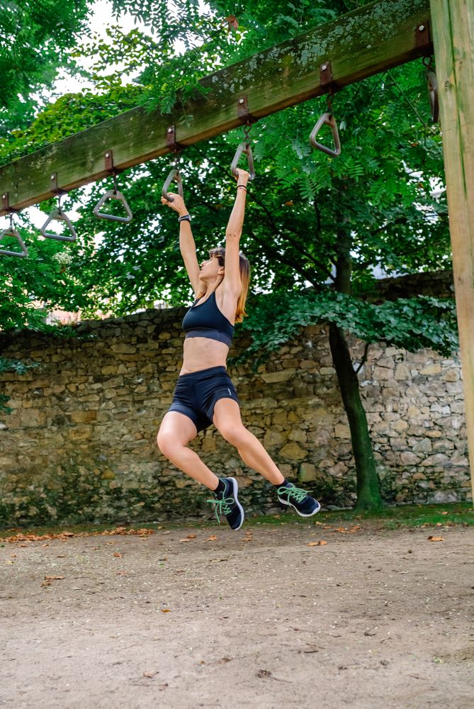 Woman doing monkey exercises on rings