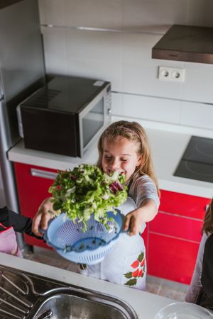 Kids playing while preparing vegetables for salad