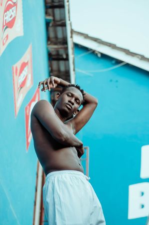 African man wearing light shorts standing outdoor